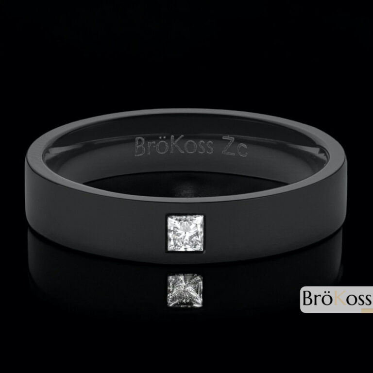 Anillo compromiso hombre gay y hetero acostado sobre fondo elegante, zirconio negro con diamante blanco cuadrado
