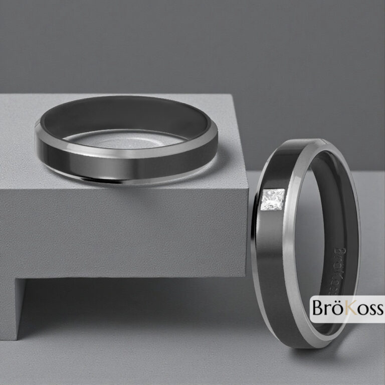 Dos anillos de boda masculinos en zirconio gris y negro, uno con diamante cuadrado y otro liso, sobre fondo de fibra de carbono