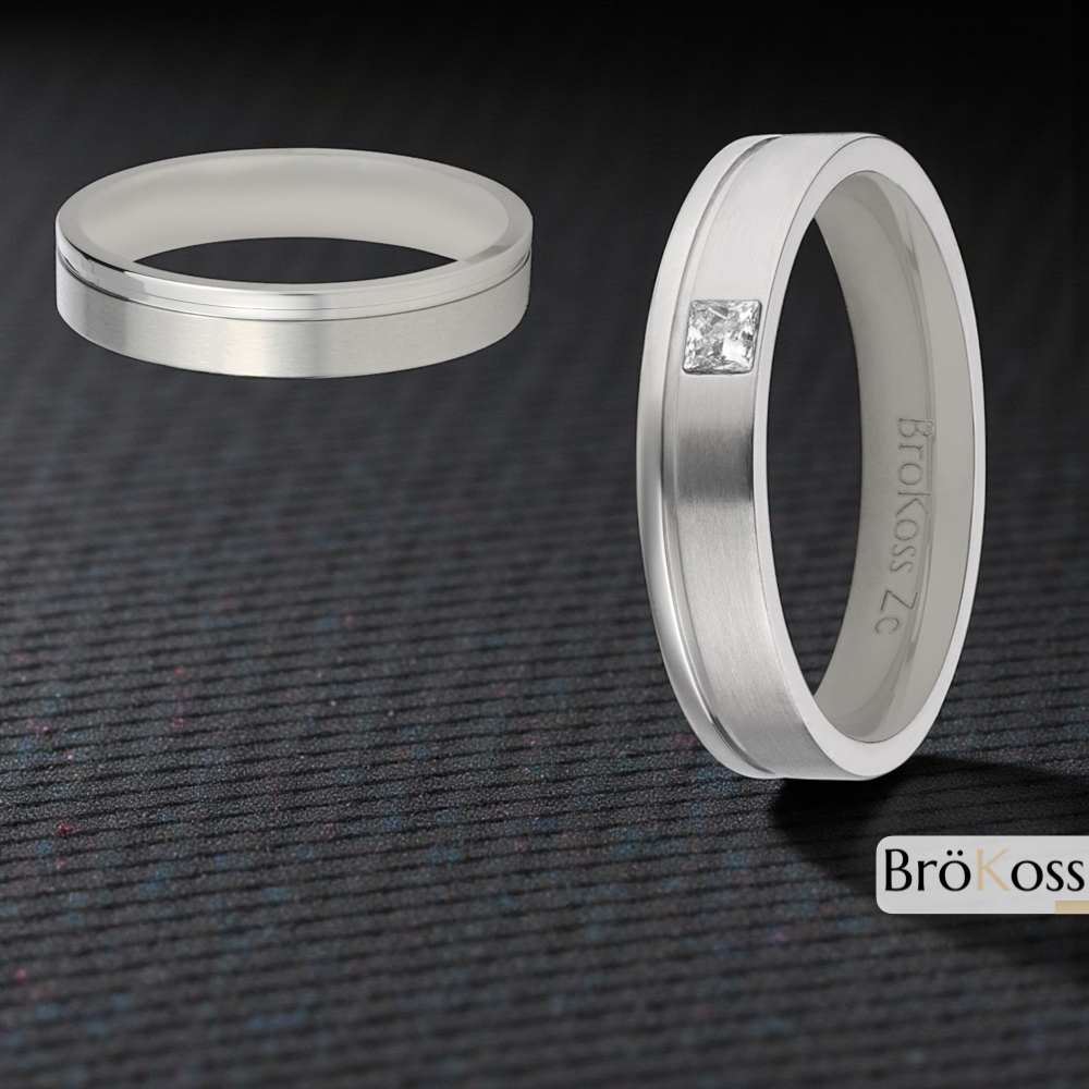 Conjunto de alianzas hombre estilo oro blanco, una lisa y otra con diamante cuadrado, sobre fondo negro fibra de carbono